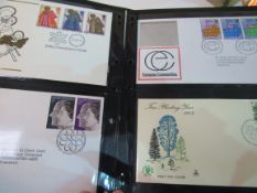 Box of First Day Covers in 3 albums and loose stamps 1960-2006.