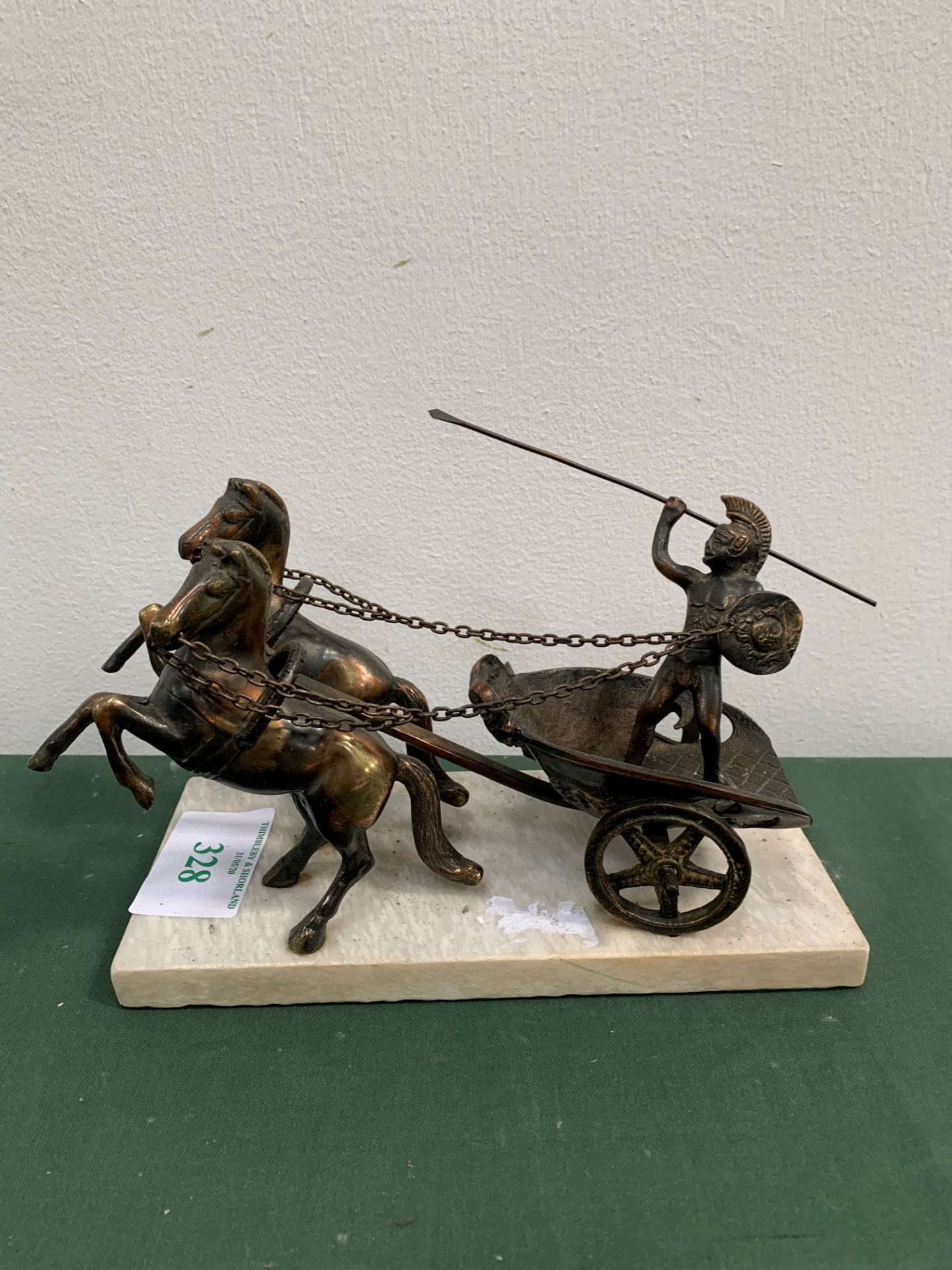 Art Deco bronze Roman Charioteer with pair of horses on white marble base.