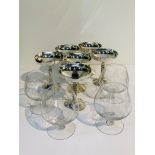 A set of 6 white metal champagne coupes together with 4 large cut glass brandy balloons.