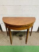 inlaid mahogany demi-lune shaped fold-over top card table with gate leg, on tapered legs.