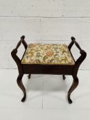 A mahogany framed piano stool.