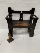 Early 20th Century oak hall chair, and a metal lion doorstop.