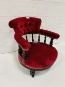 Red velvet upholstered rail backed tub open armchair on casters.