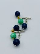Pair of lapis lazuli cufflinks and a pair of jade and lapis lazuli cufflinks.