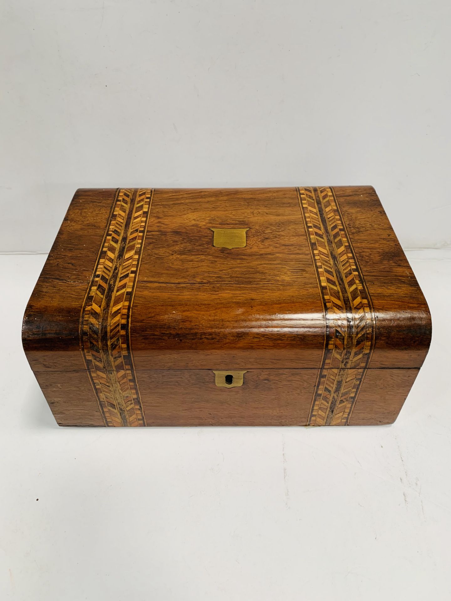 An inlaid fruitwood sewing box; a mahogany desk tidy; and a mahogany miniature refectory table.