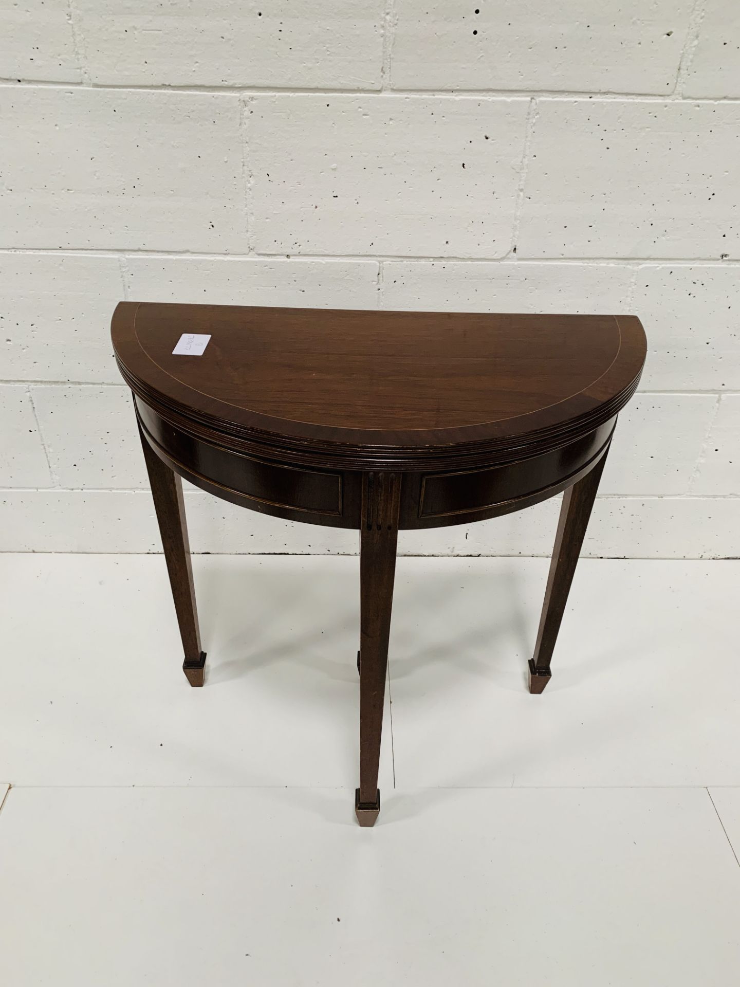 Mahogany demi-lune folding top card table.