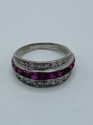18ct white gold Art Deco diamond and ruby half eternity ring. Size O. Weight 4.6 gms