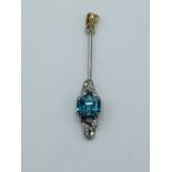 White metal pendant set with a pale blue stone and diamonds.