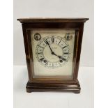 A mahogany cased mantel clock by Birch & Gaydon Ltd., London.
