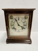 A mahogany cased mantel clock by Birch & Gaydon Ltd., London.