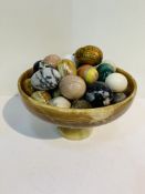 Onyx bowl on stand with a collection of 34 stone "eggs".