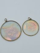 2 glass hologram pendants set in 9ct gold.