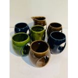 Set of 6 Holkham pottery owl mugs T106: 2 green, 2 blue, 2 brown; and a brown creamer