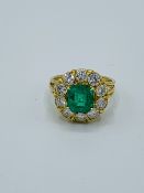 Emerald and diamond cluster ring.