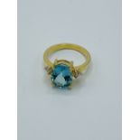 18ct gold ring set with an oval pale blue stone (possibly tourmaline) and diamonds.