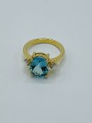 18ct gold ring set with an oval pale blue stone (possibly tourmaline) and diamonds.