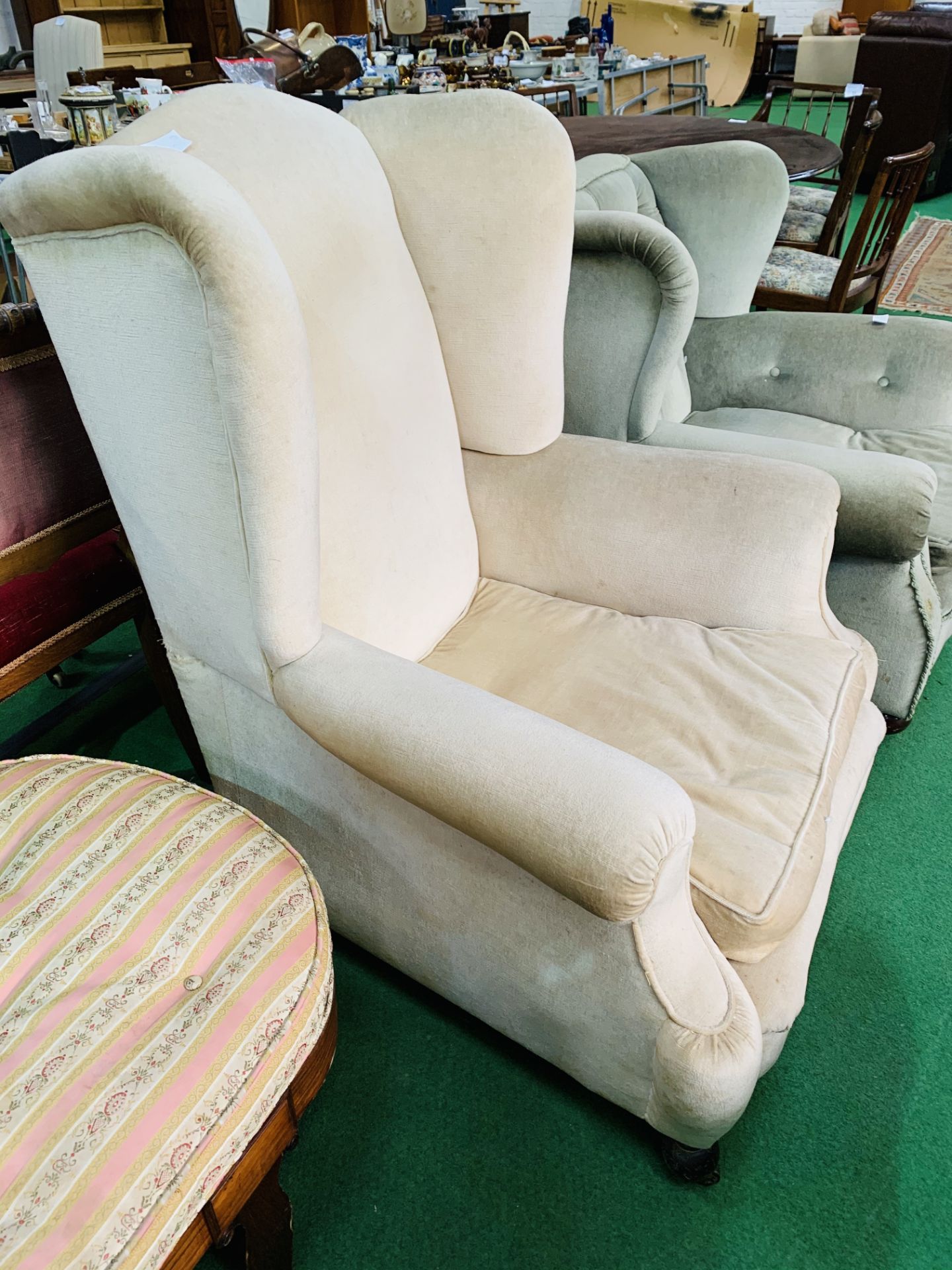 A large beige upholstered Victorian armchair on casters. 92 x 90 x 110cms. - Image 2 of 2