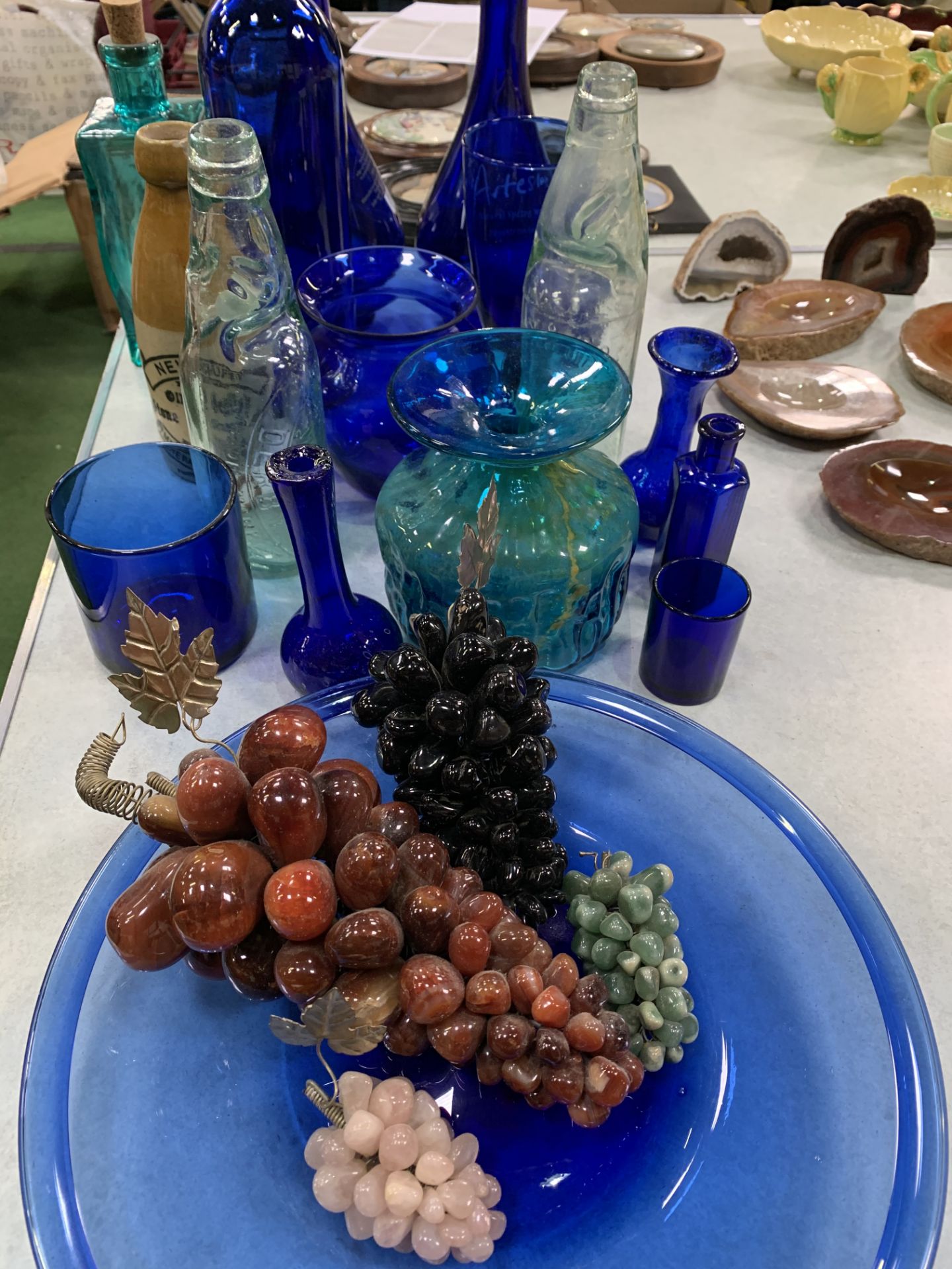 11 pieces of blue glass; 4 glass grape bunches; Art glass blue and yellow vase; and vintage bottles