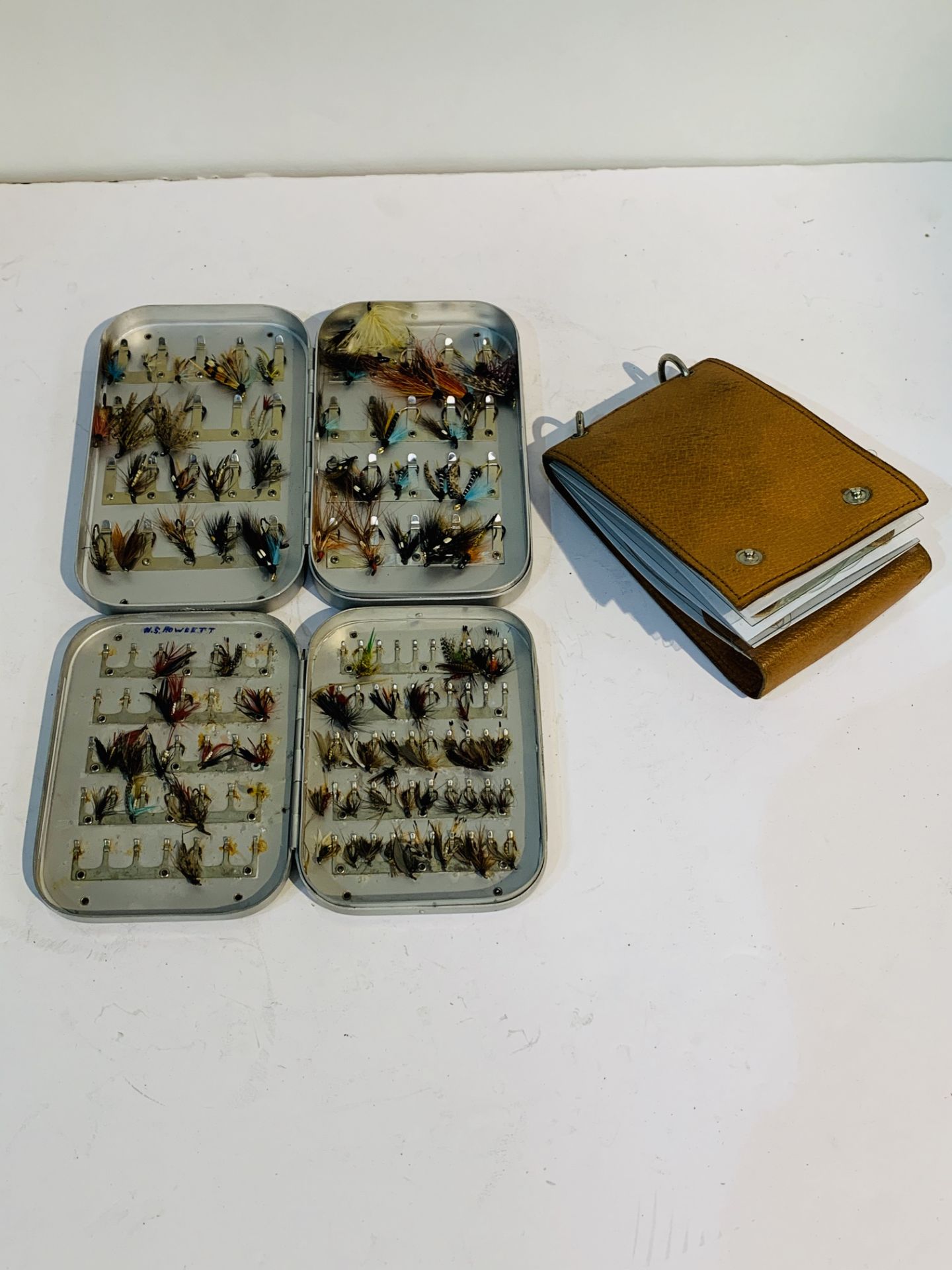 Two cases of fly fishing flies together with a Jackson's cast book.