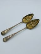 2 George III silver and silver-gilt berry spoons.