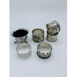 Pair of silver napkin rings, oriental silver napkin ring and three other silver pieces.