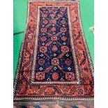 A blue ground hand knotted rug 220 x 126cms.