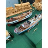 Three model wooden boats.