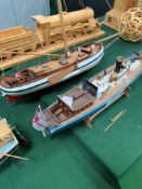 Three model wooden boats.