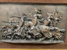 A framed relief panel depicting a mediaeval cavalry charge, 27 x 49cms. Estimate £20-40.