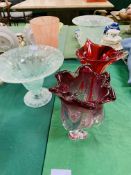 Four various glass vases and a bowl on a stand.