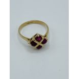 9ct gold ring set with 4 red stones in a square.