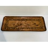 A Newlyn Arts and Crafts copper tray and another tray.