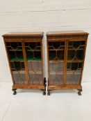A pair of flame mahogany glass fronted small bookcases.