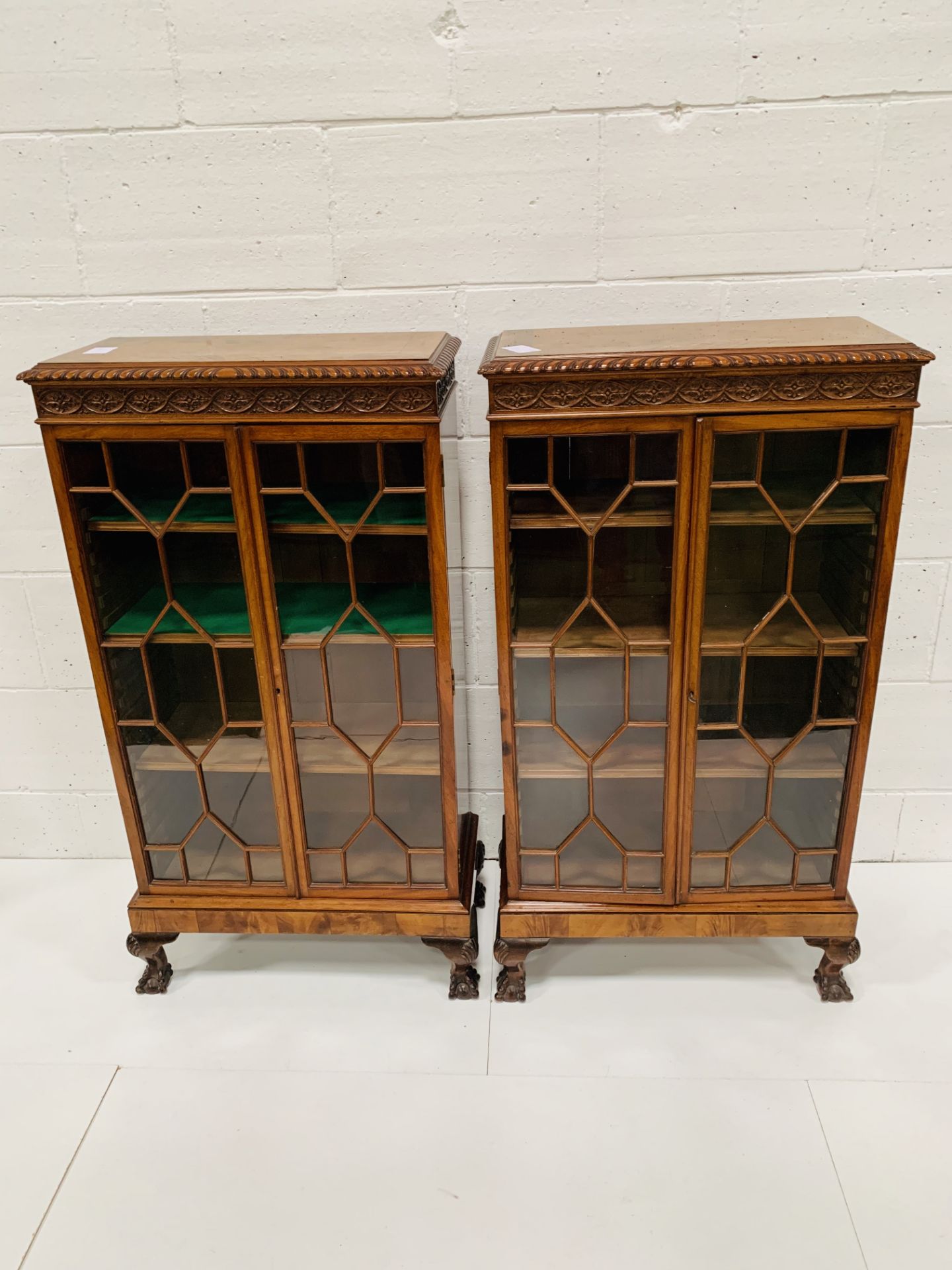 A pair of flame mahogany glass fronted small bookcases.