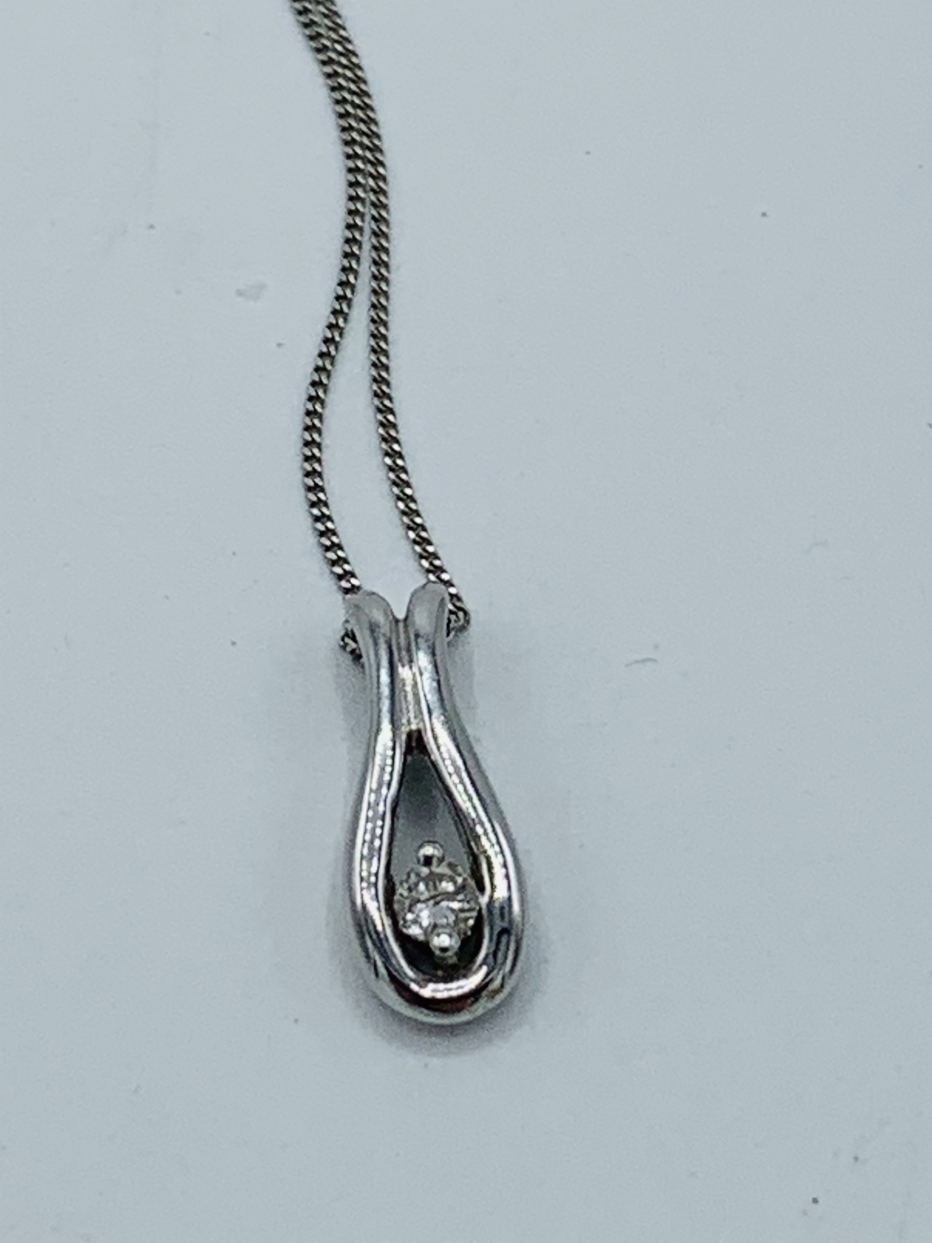 9k white gold diamond pendant.