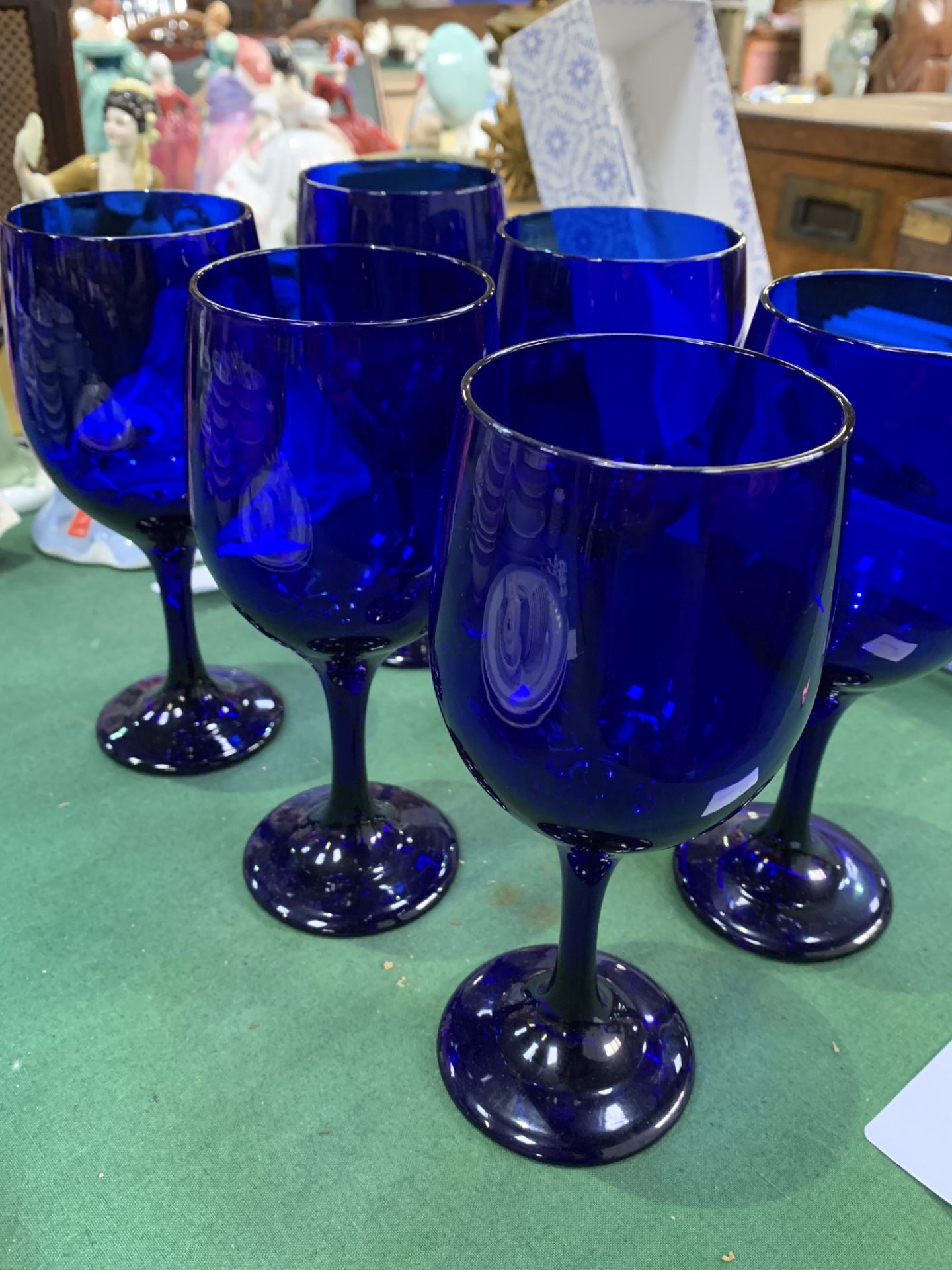 Six blue glass goblets.