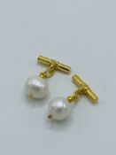 Pair of pearl and yellow metal cufflinks.