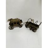Two brass models: stagecoach and chuck wagon.