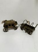 Two brass models: stagecoach and chuck wagon.