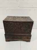 Small carved oak chest with drawer beneath.