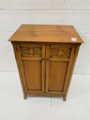 Arts and Crafts style oak two door cabinet.