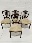 Four mahogany shield back dining chairs.