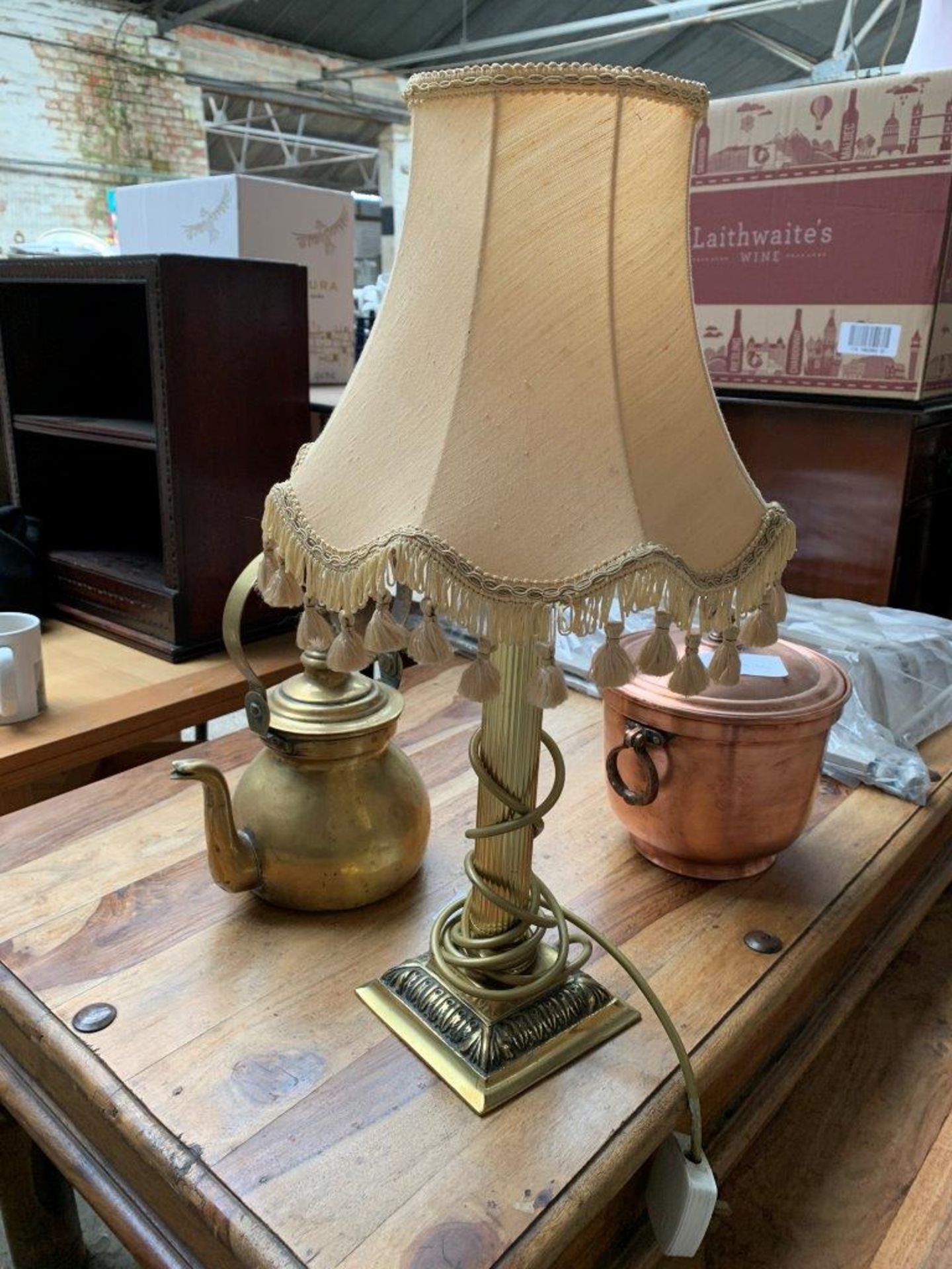 A copper covered pot; a brass kettle; together with a brass table lamp.