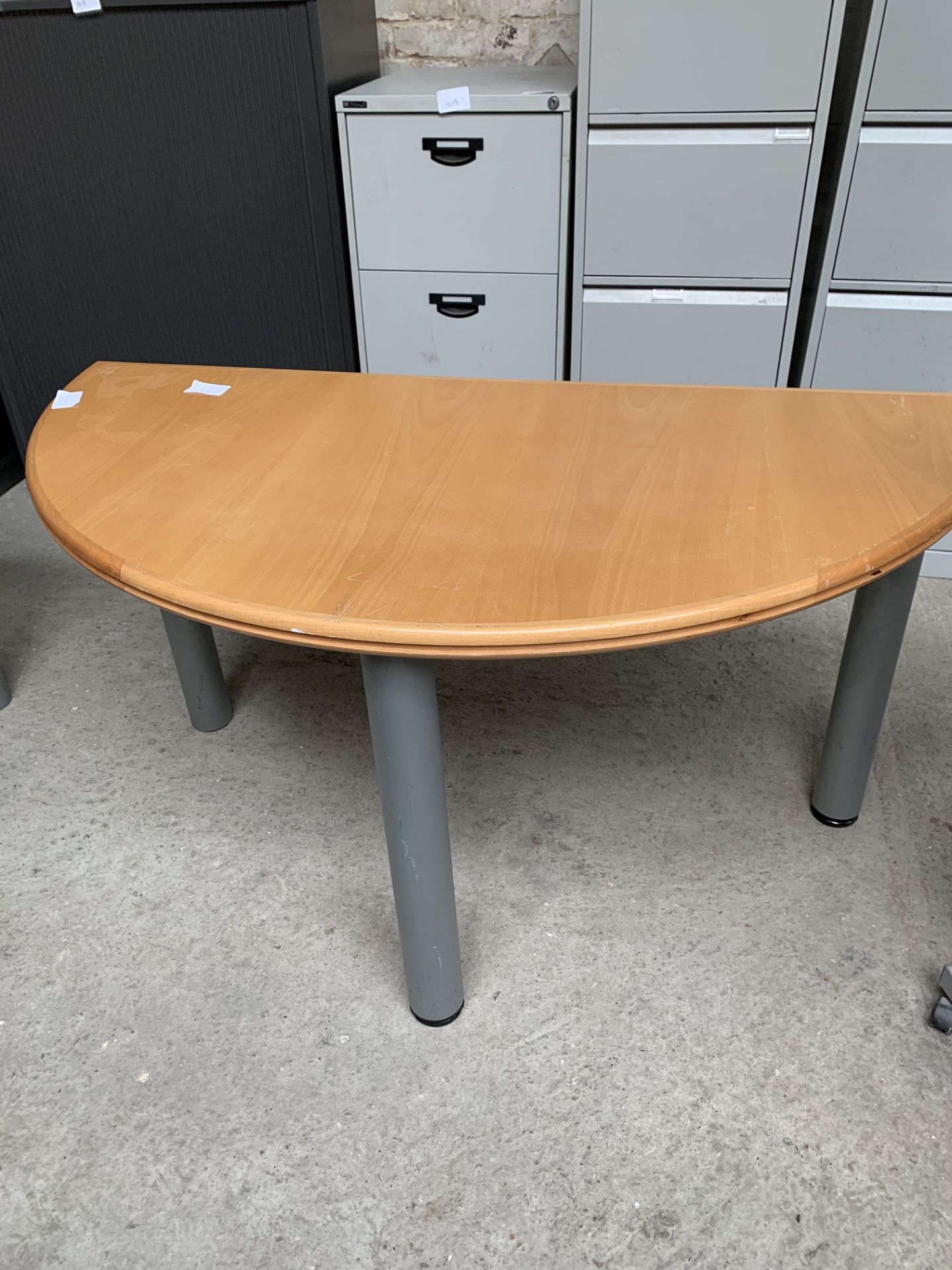 Laminate demi-lune table on metal supports. 140 x 70 x 71cms.