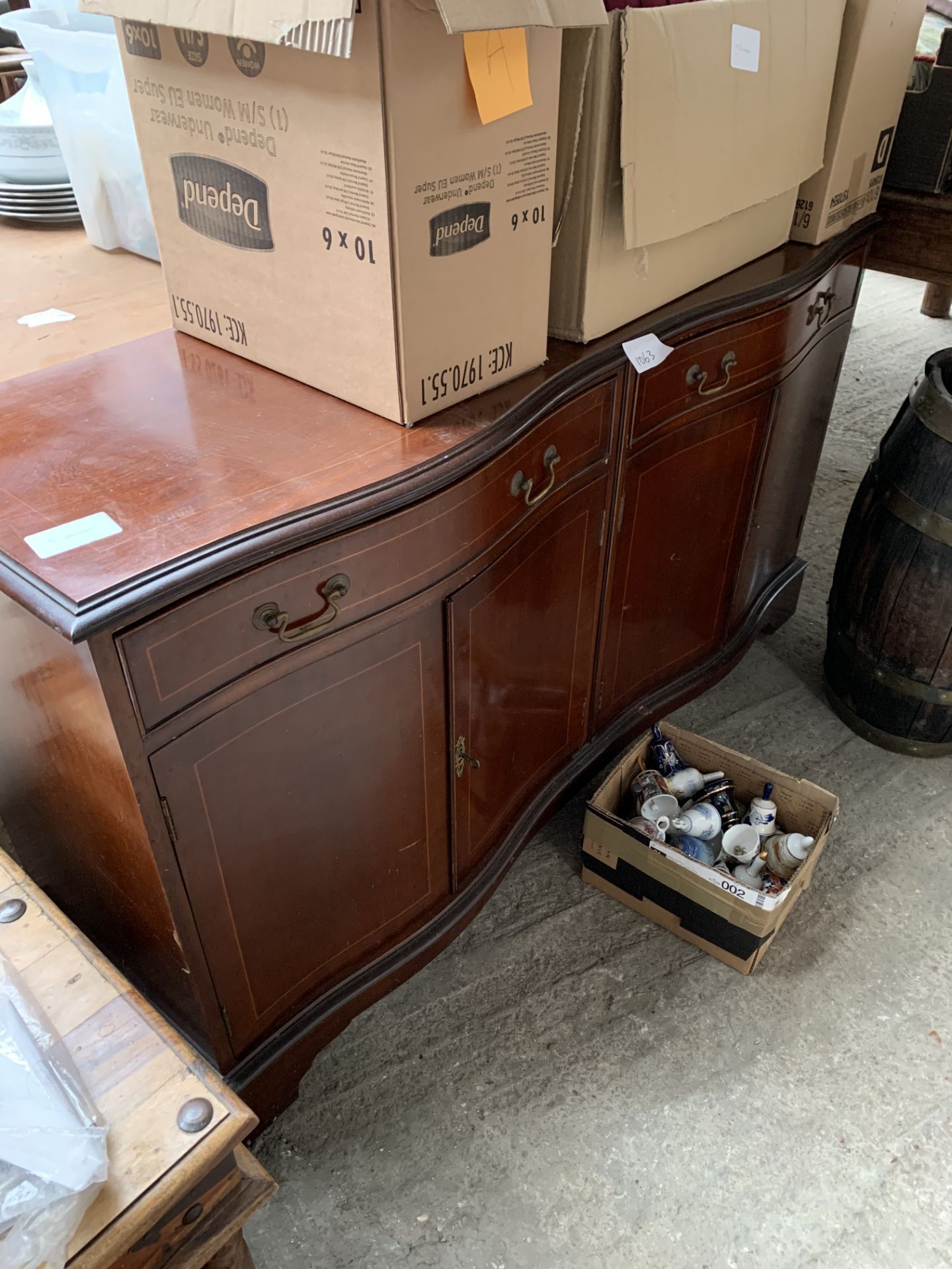 Mahogany serpentine fronted sideboard with two frieze drawers over two cupboards, 142 x 46 x 78cms.