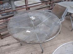 Outdoor metal round table with four chairs.