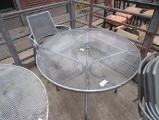 Outdoor metal round table with four chairs.