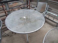 Outdoor metal round table with four chairs.