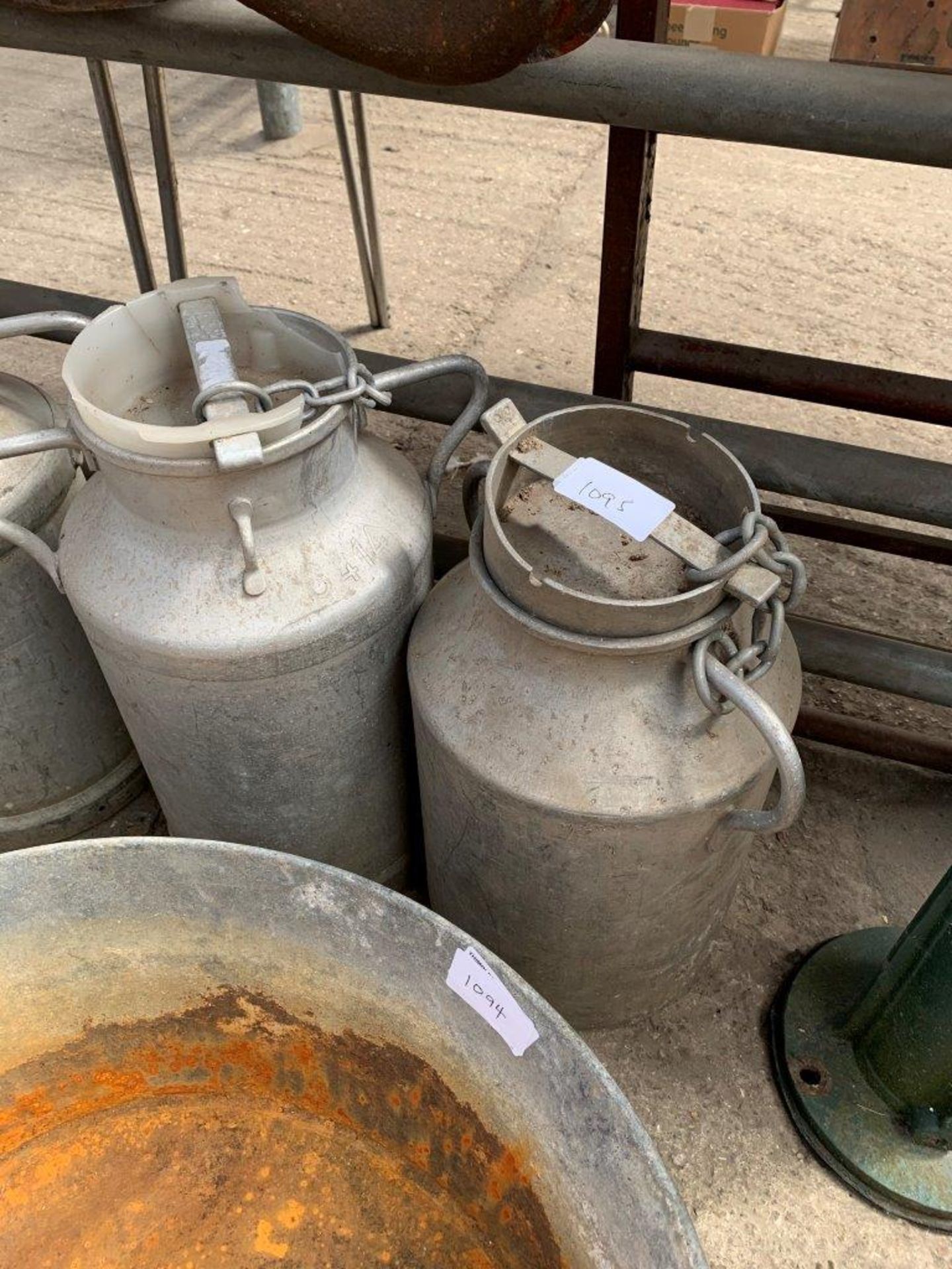 2 aluminium churns with lids.