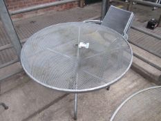 Outdoor metal round table with four chairs.